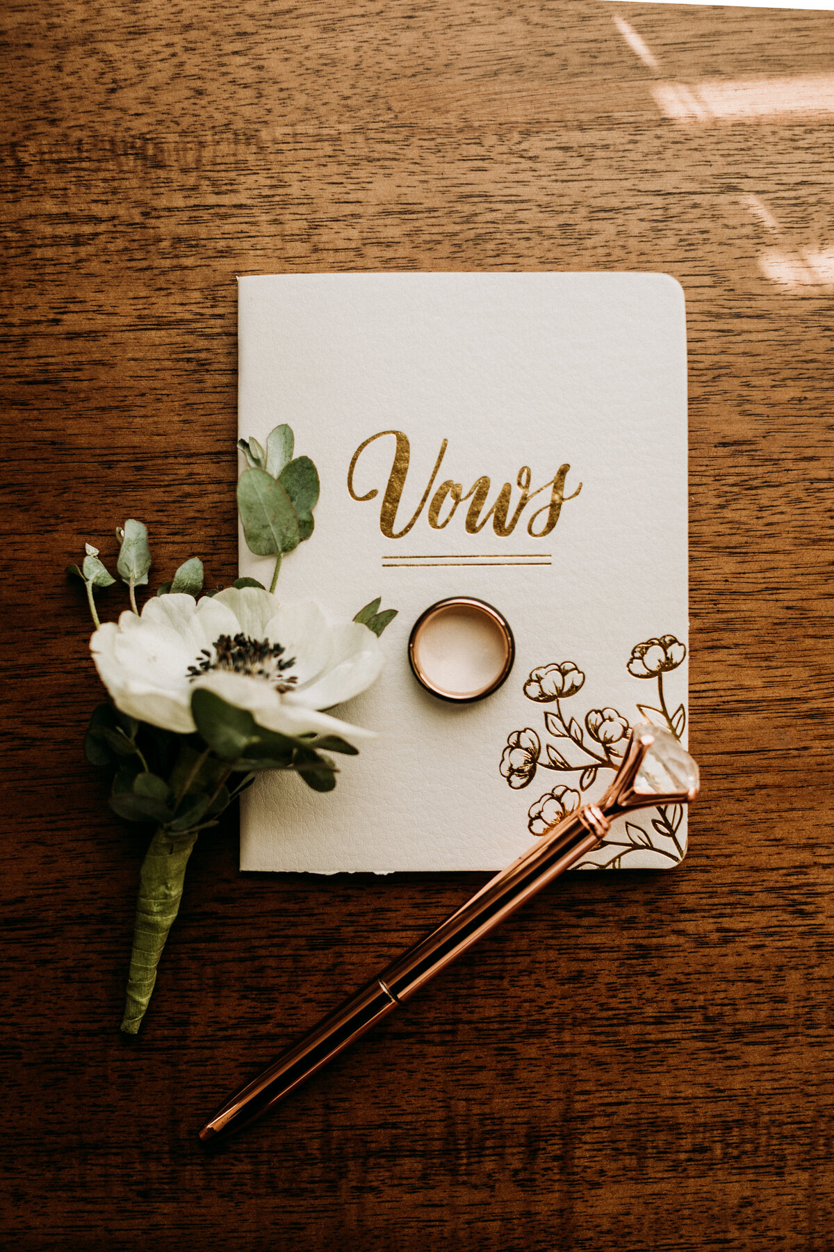 Vow book with ring and flowers  on top as details for Iowa elopement
