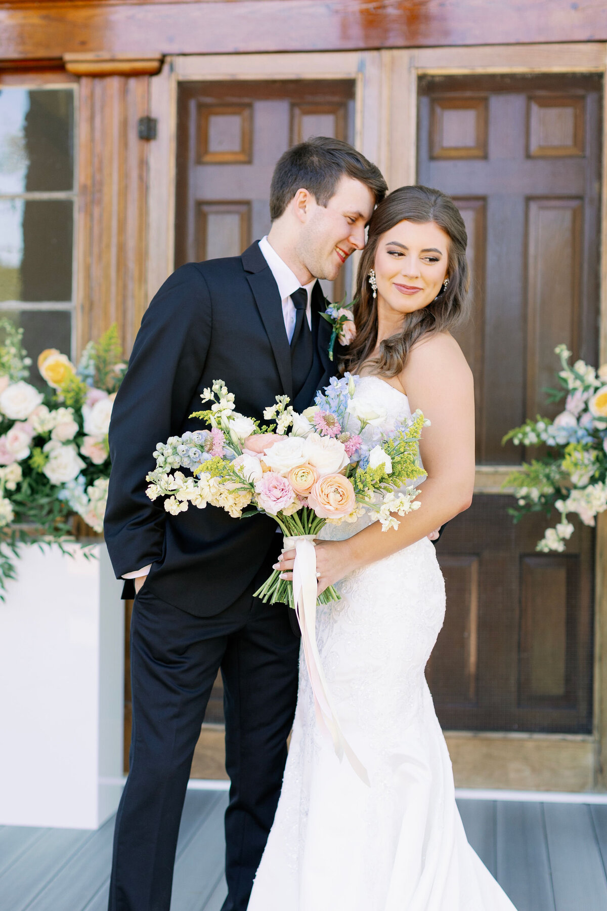 Bride and groom with colorful flowers