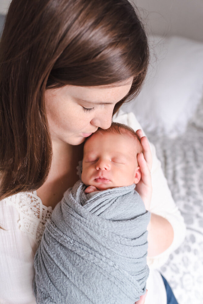 denver-new-baby-in-home-session-mom-kissing-baby