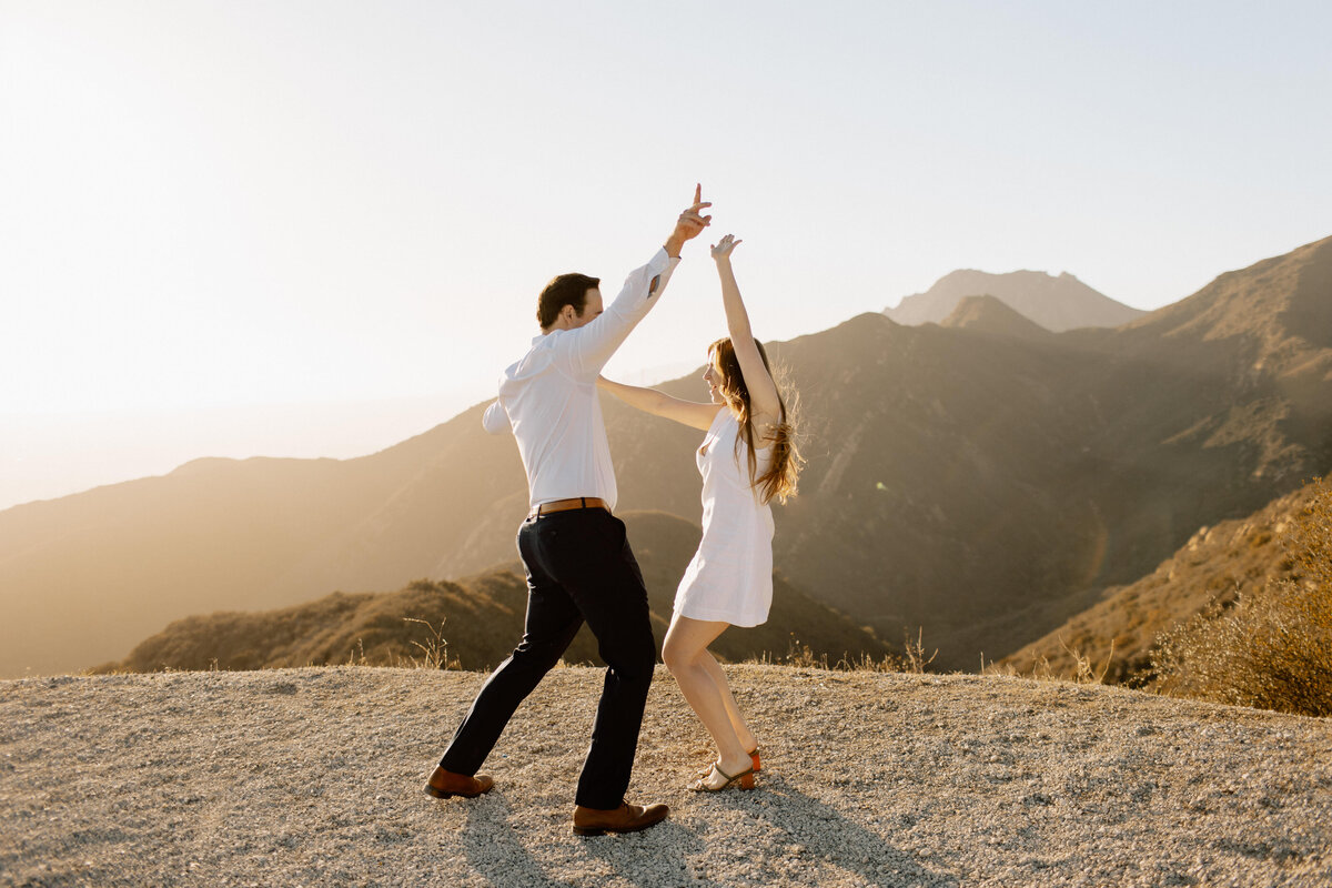 engaged couple dancing on hill in santa barbara california