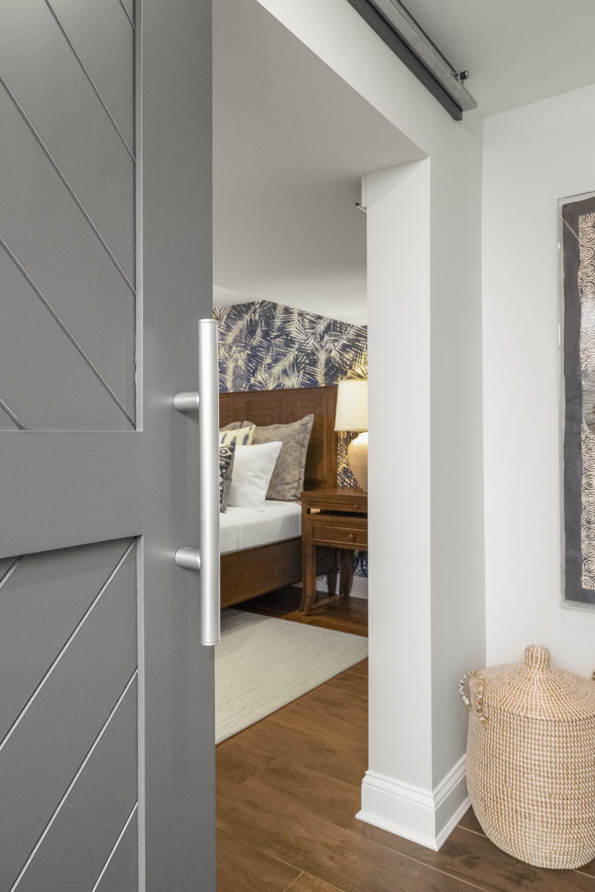 candra lynn interiors ocean port project bedroom with sliding door and wooden floors