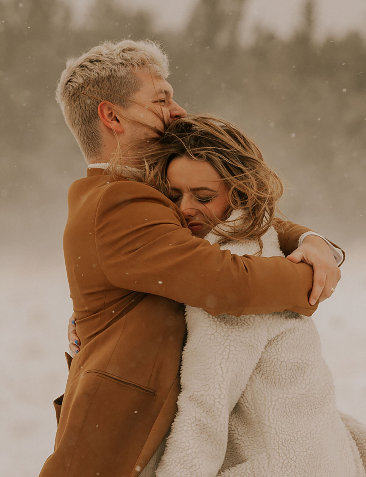 elopement couple embraces in their wedding attire on a snowy winter day in Bend, OR