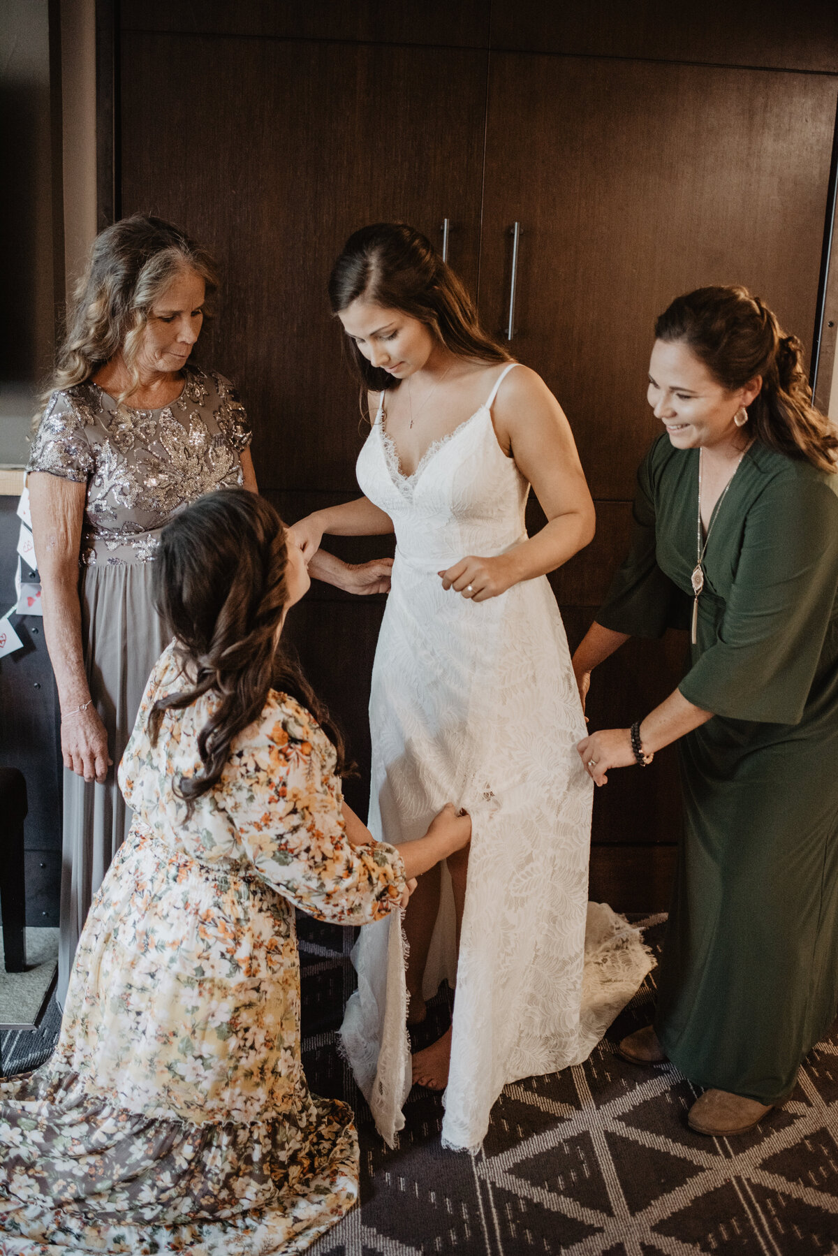 Photographers Jackson Hole capture women helping bride with dress