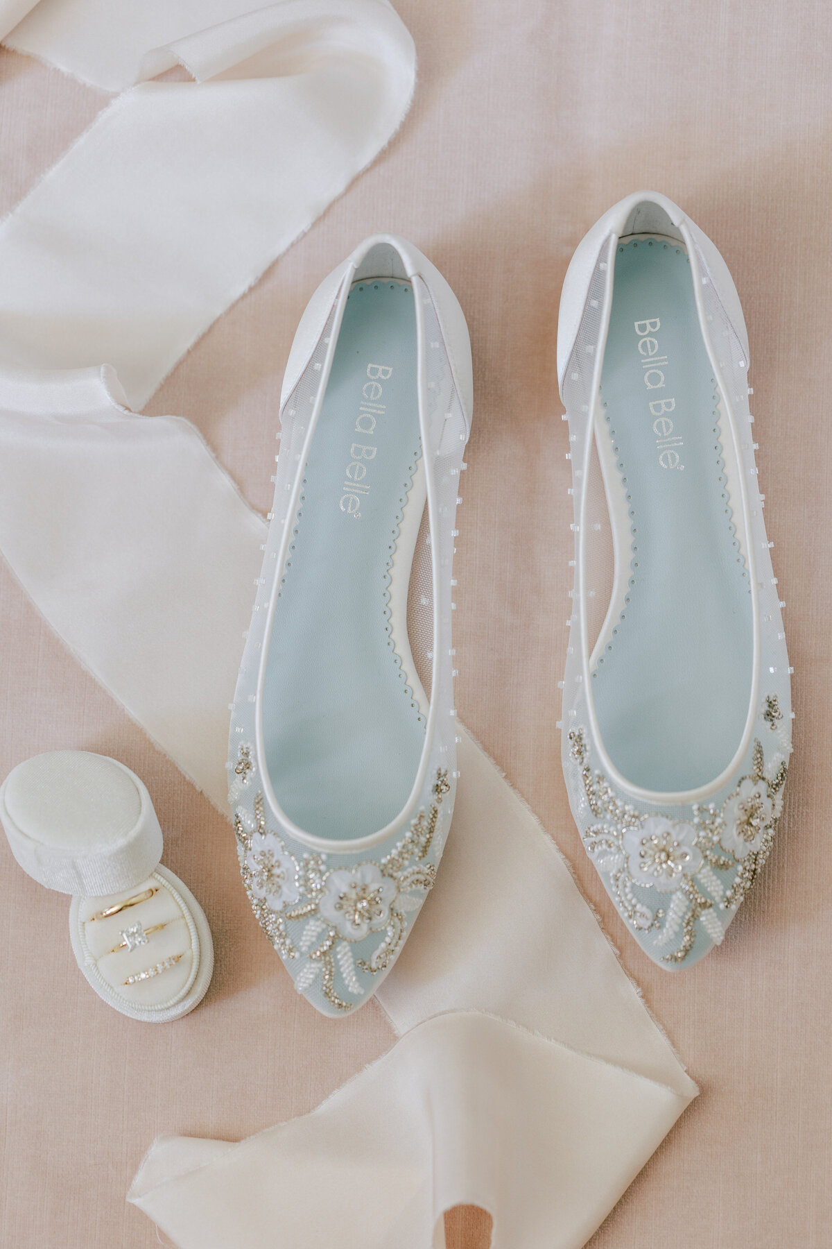 White flats shoes and a  white box with 3 rings