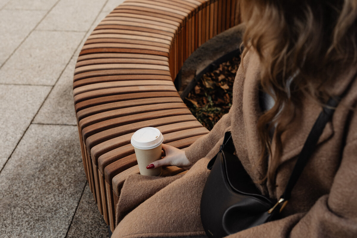 A woman holding a coffee cup from a cafe. By working with an anxiety therapist in NYC, NY then you can develop coping strategies for your anxiety. Start anxiety therapy today.