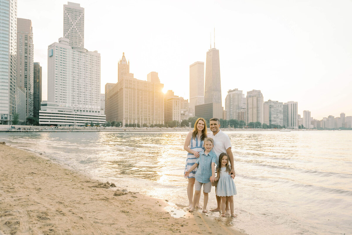 Family of four on Ohio St Beach for their chicago family photos