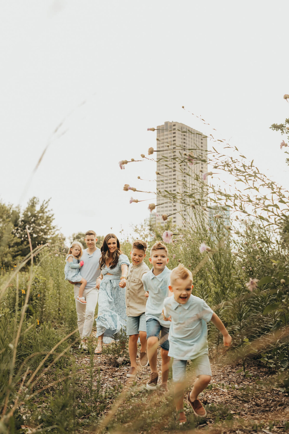 Elly Brown and family hold hands during a walk through the park in Houston Texas.