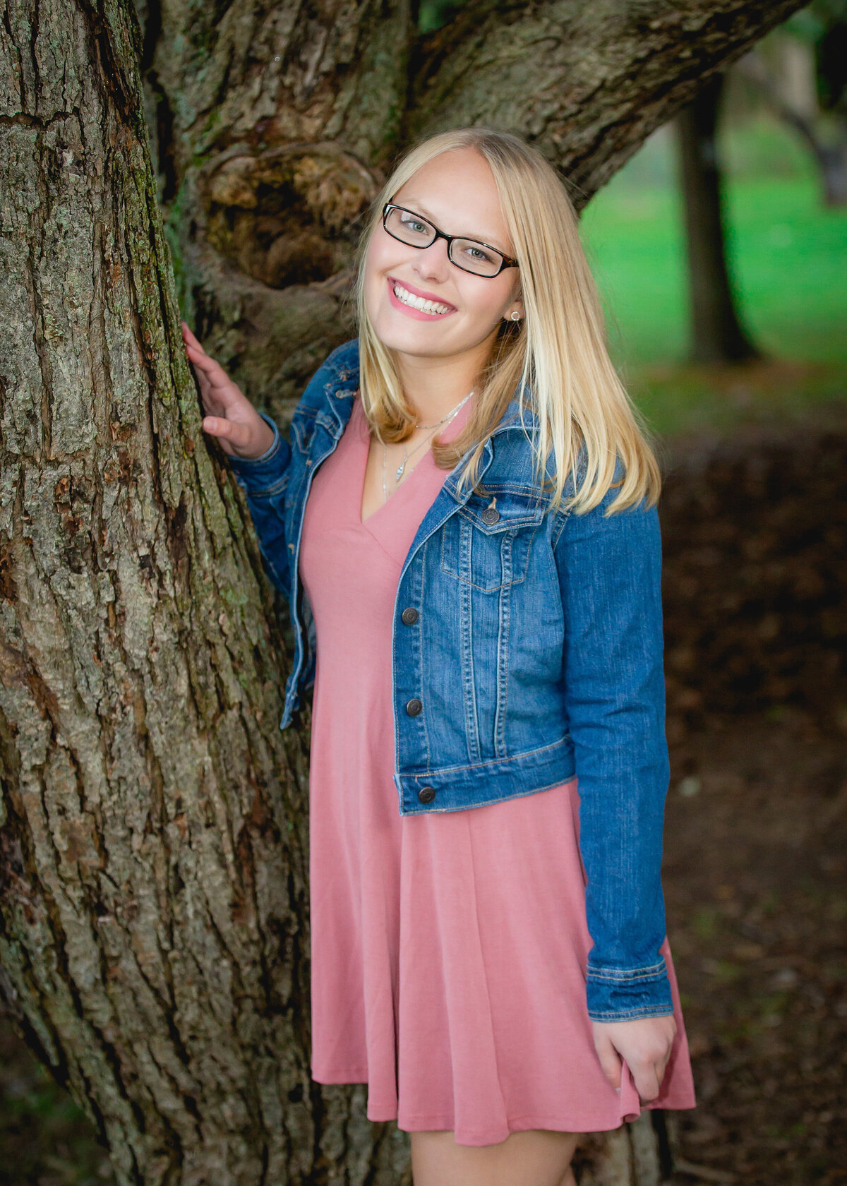 Senior girl in glasses by a tree at Mendon Ponds Park