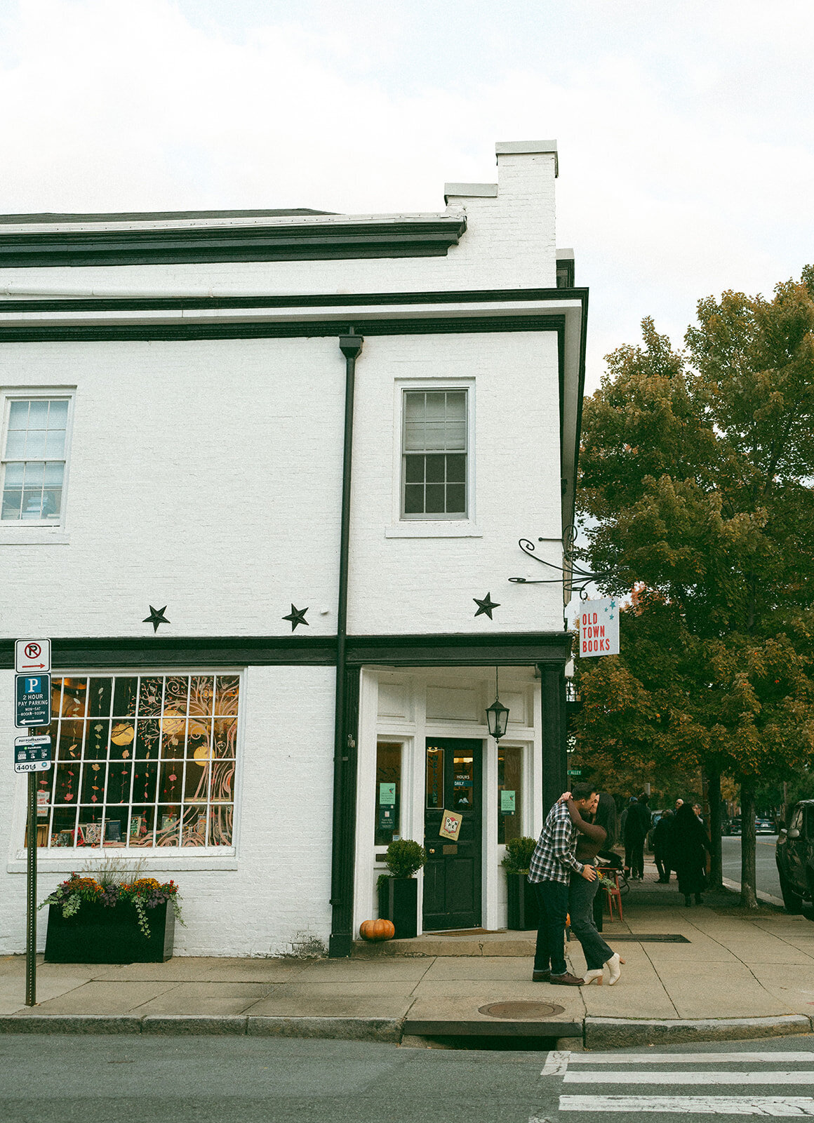 Engaged couple standing on a brick-lined street in Old Town Alexandria, Virginia during a documentary-style session