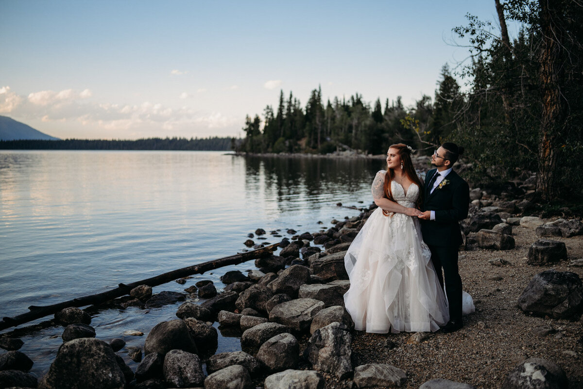 Blue Hour fades at Jenny Lake where eloping couple stand next to water