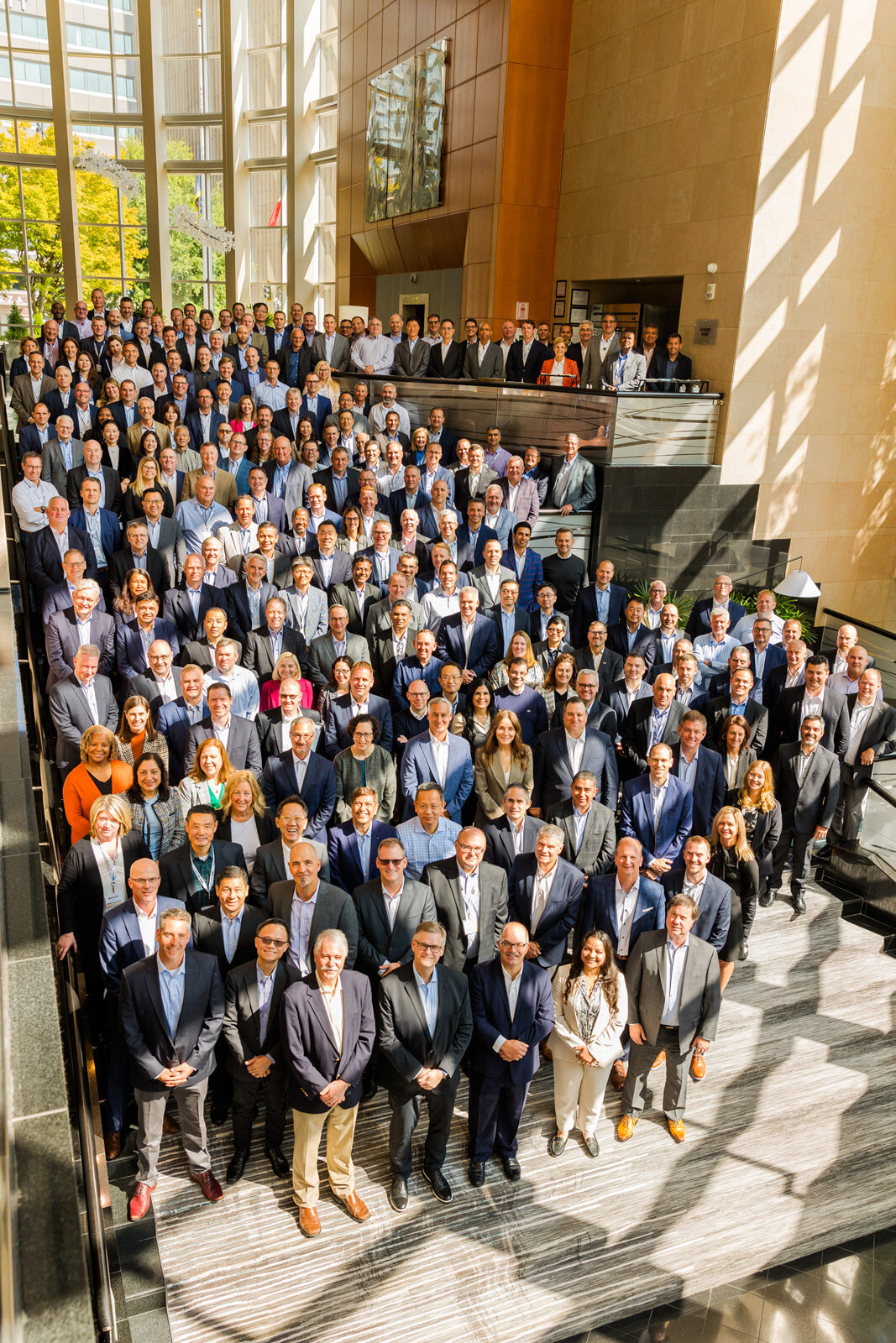 colleague group of 100 + collegues standing on hotel stairs during convention group photos in Atlanta Buckhead Westin hotel by Laure Photography
