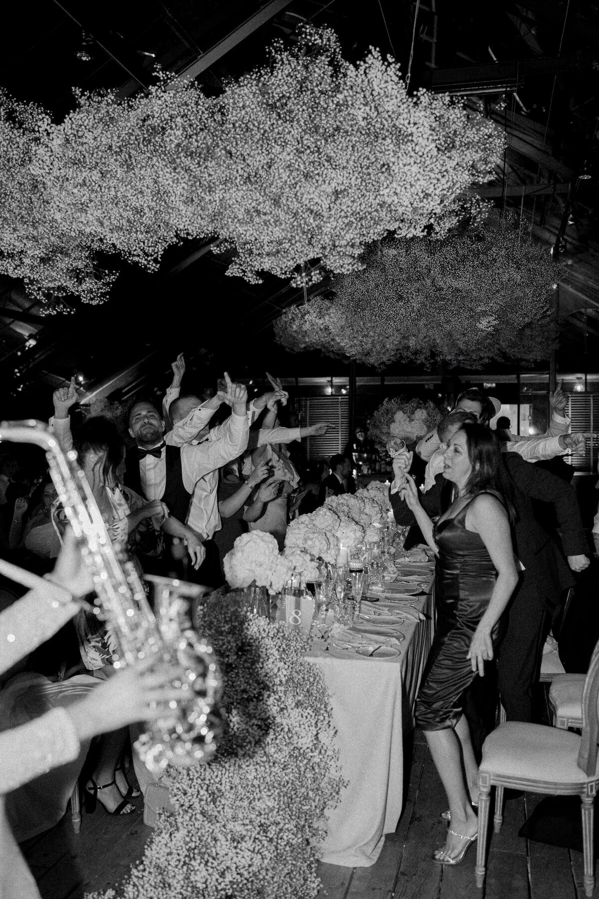 Guests dance to the sound of a saxophone being played at a Bellavista destination wedding