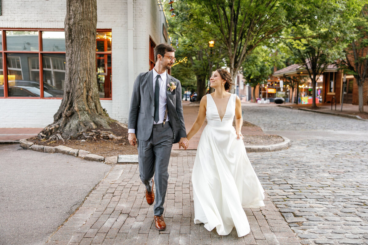 Just married couple exploring downtown Raleigh streets after Market Hall wedding