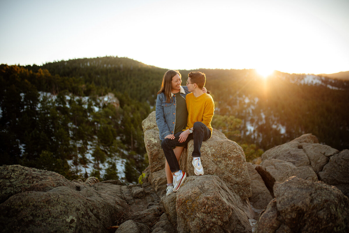 Same Sex couple photographed kissing on horsetooth rock near Fort Collins Co