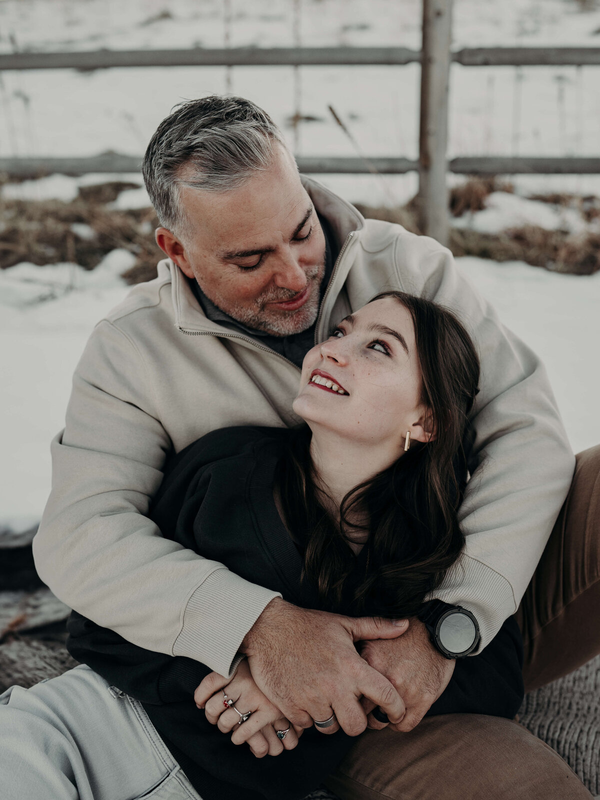 A father holds his teenage daughter as they look at each other, and he tells his brown hair blue-eyed daughter, his favorite thing about her.