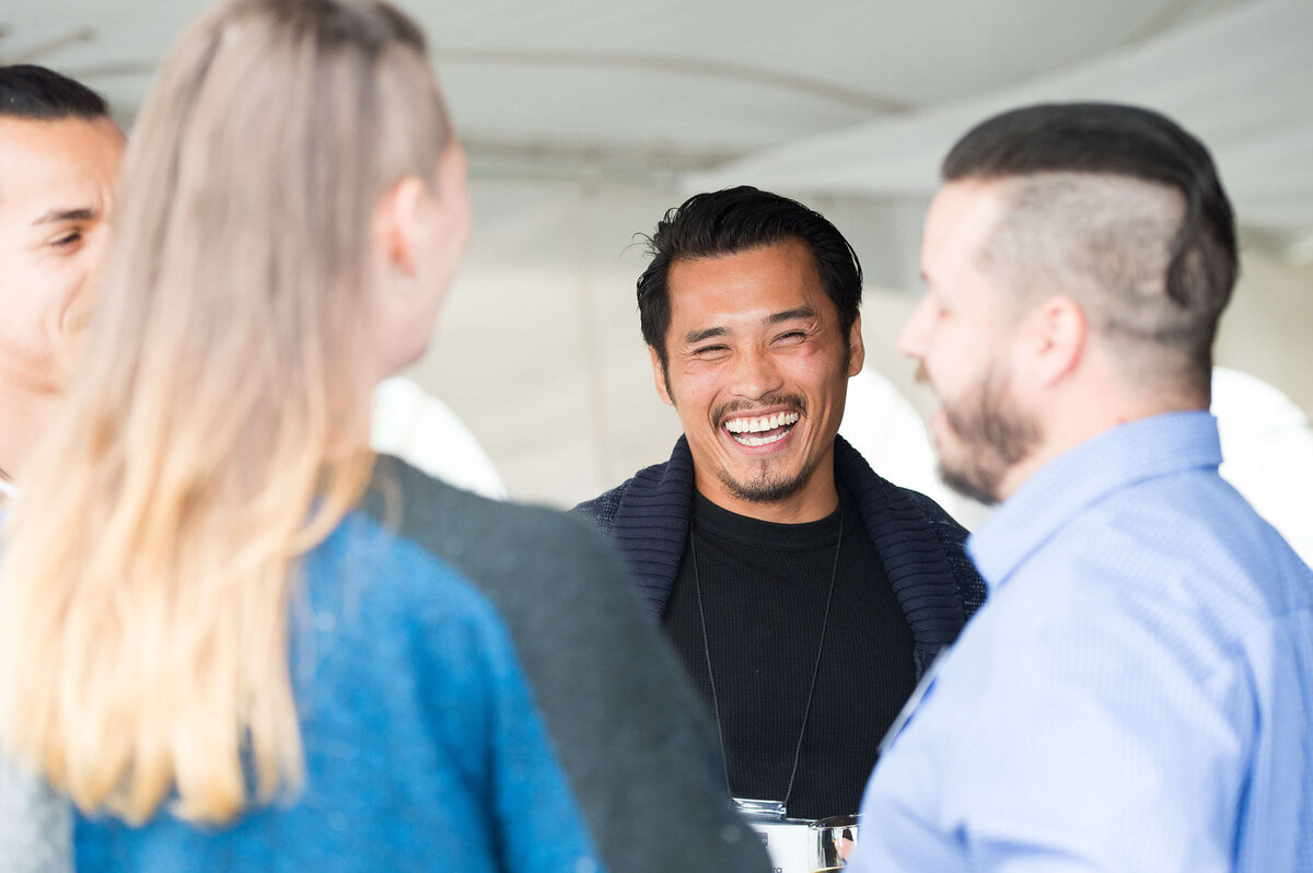a candid photo of guests mingling at a corporate anniversary celebration.  Captured by Ottawa Event Photographer JEMMAN Photography COMMERCIAL