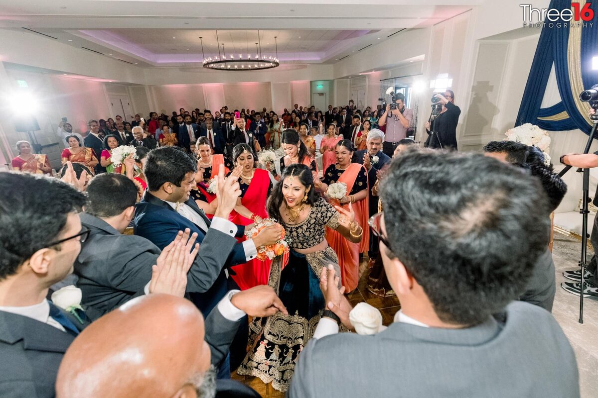 Bride and Groom are surrounded by wedding guests on the dance floor