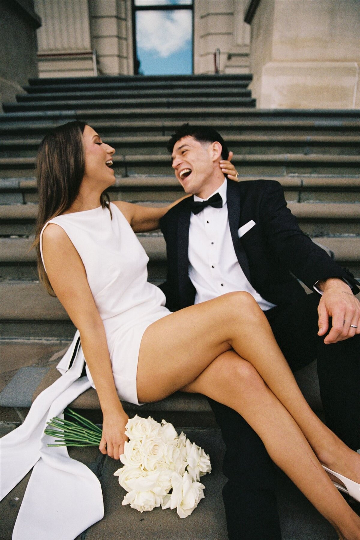 couple laughing after wedding ceremony on parliament steps in melbourne