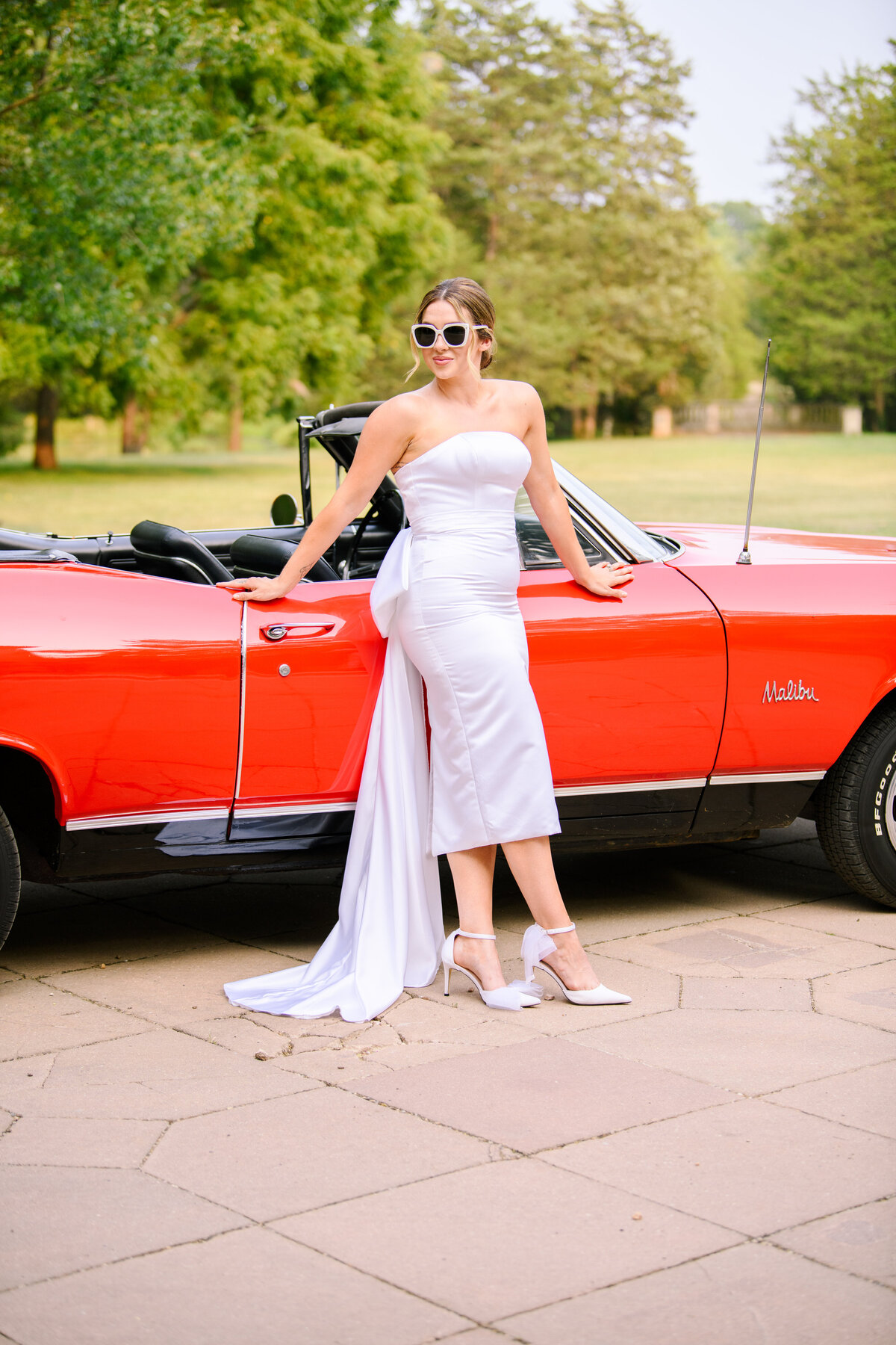 Bride in front of convertible