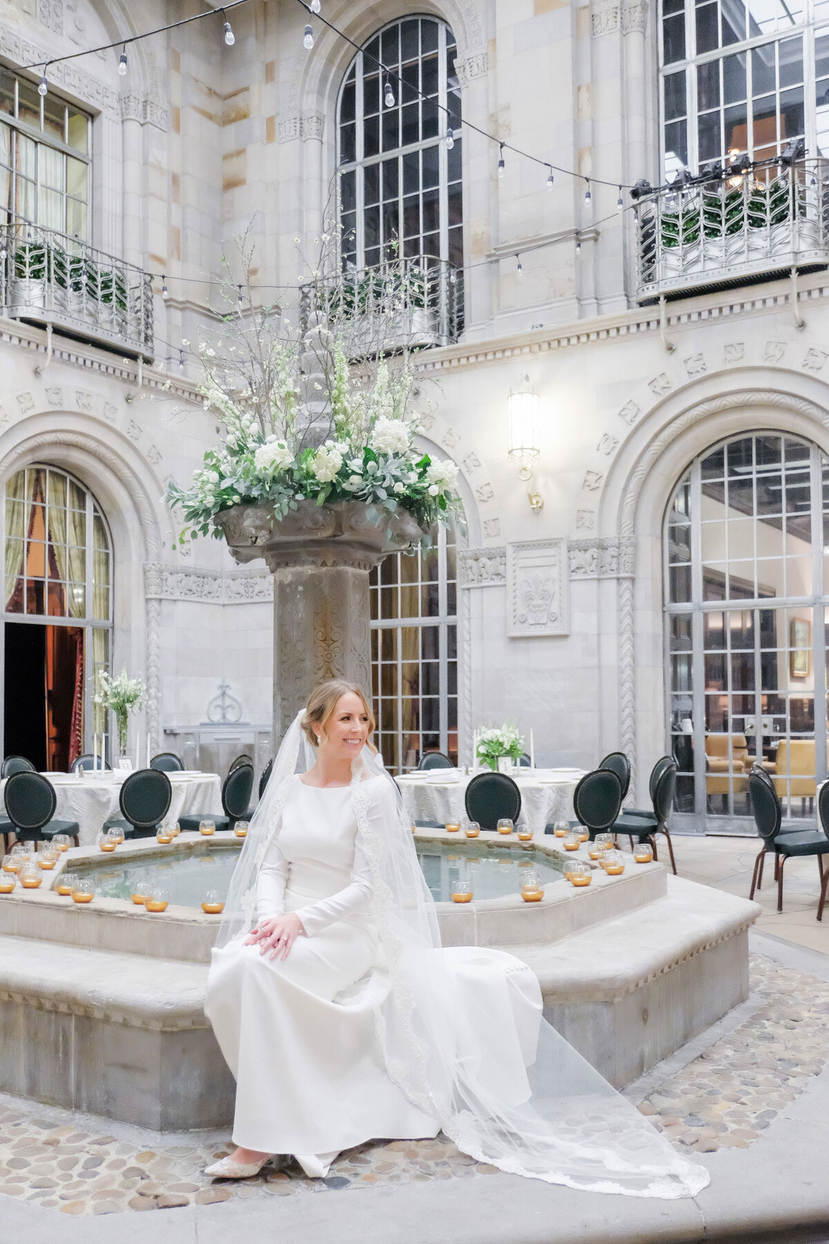 bride posing for photo in the courtyard at the duquesne club