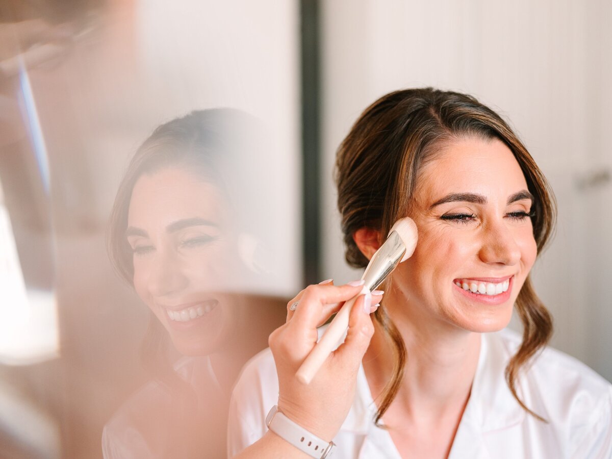 Bride receives her final makeup touches on her wedding day.