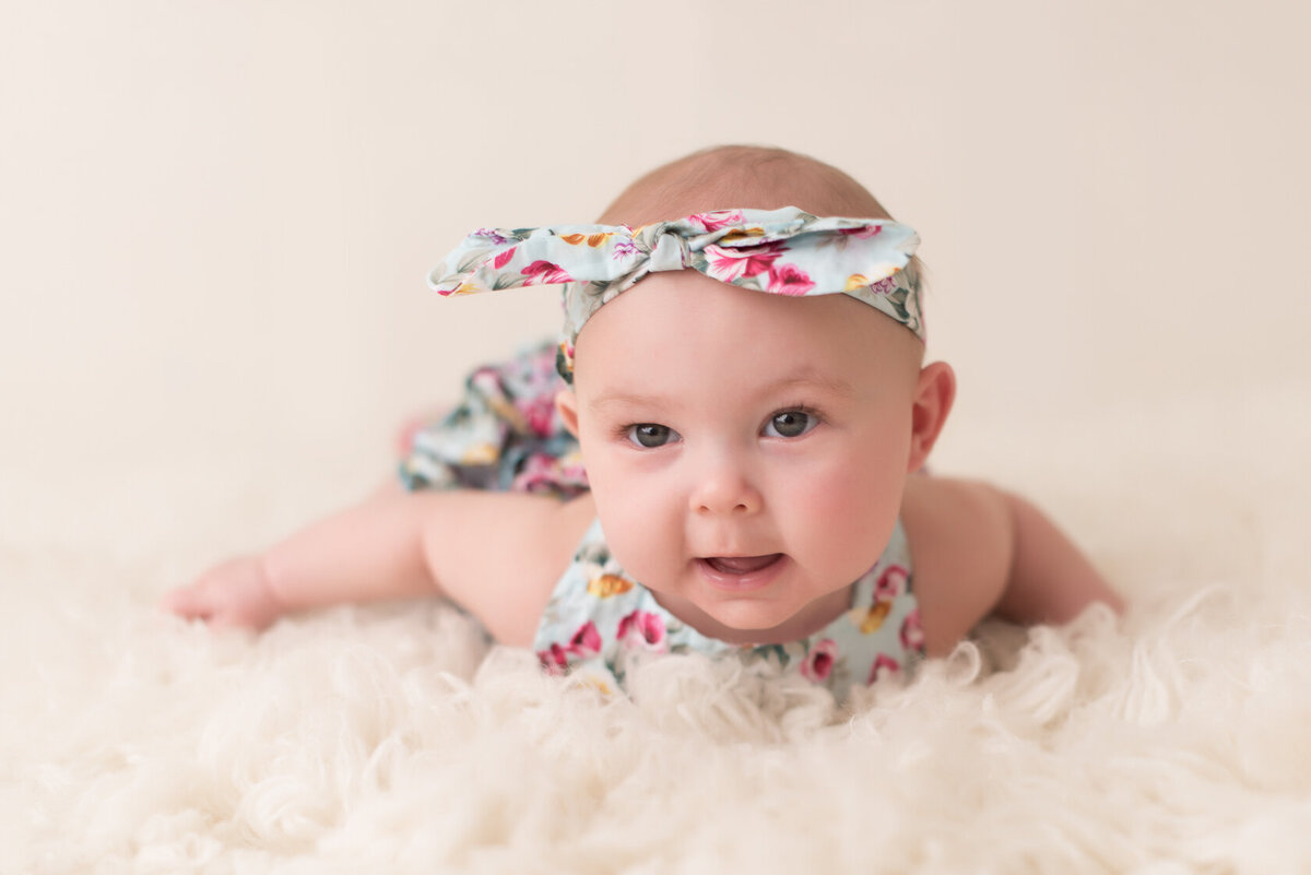 Adorable baby in cream furry background portrait