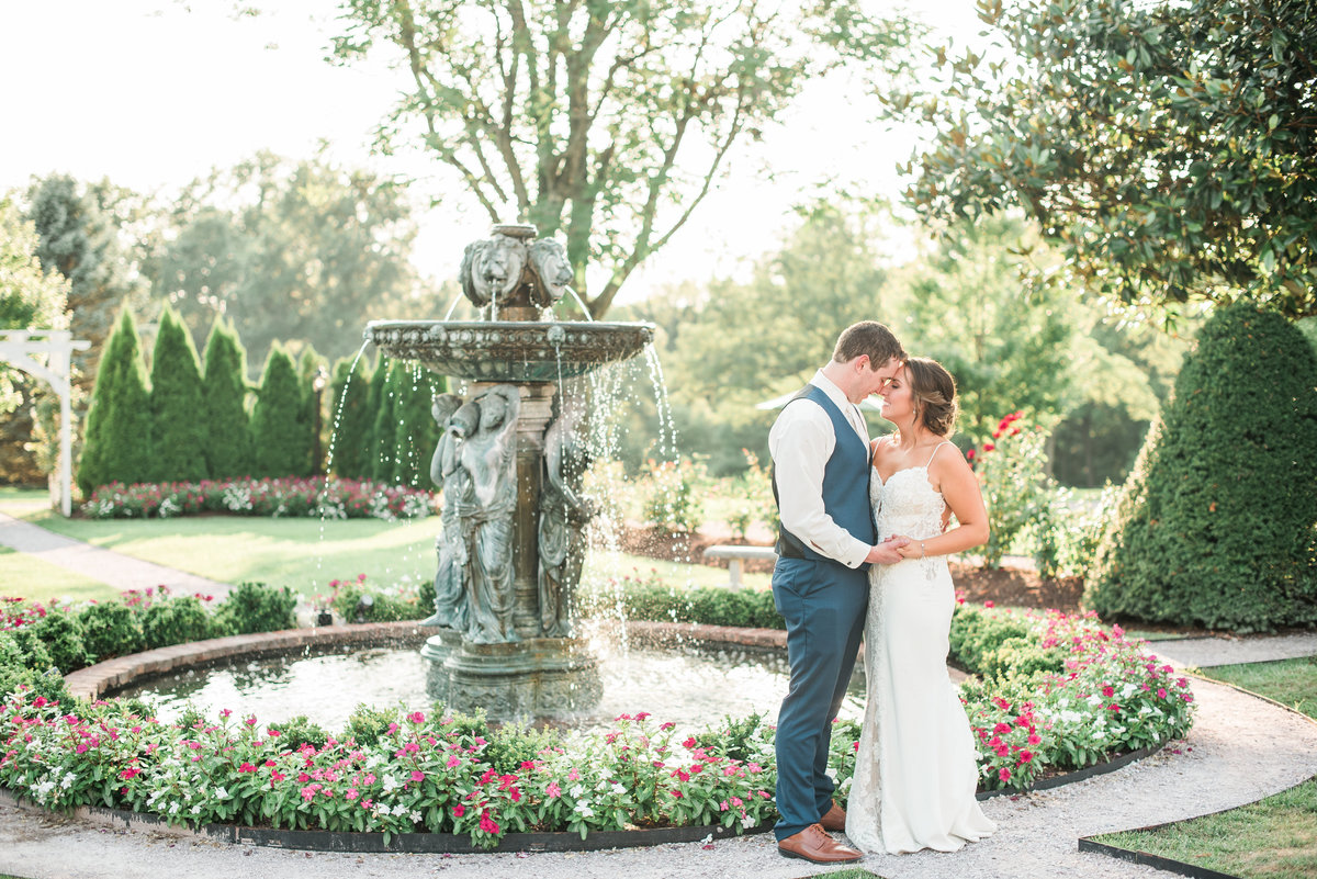 bride and groom in front of fountain at antrim 1844 maryland wedding venue