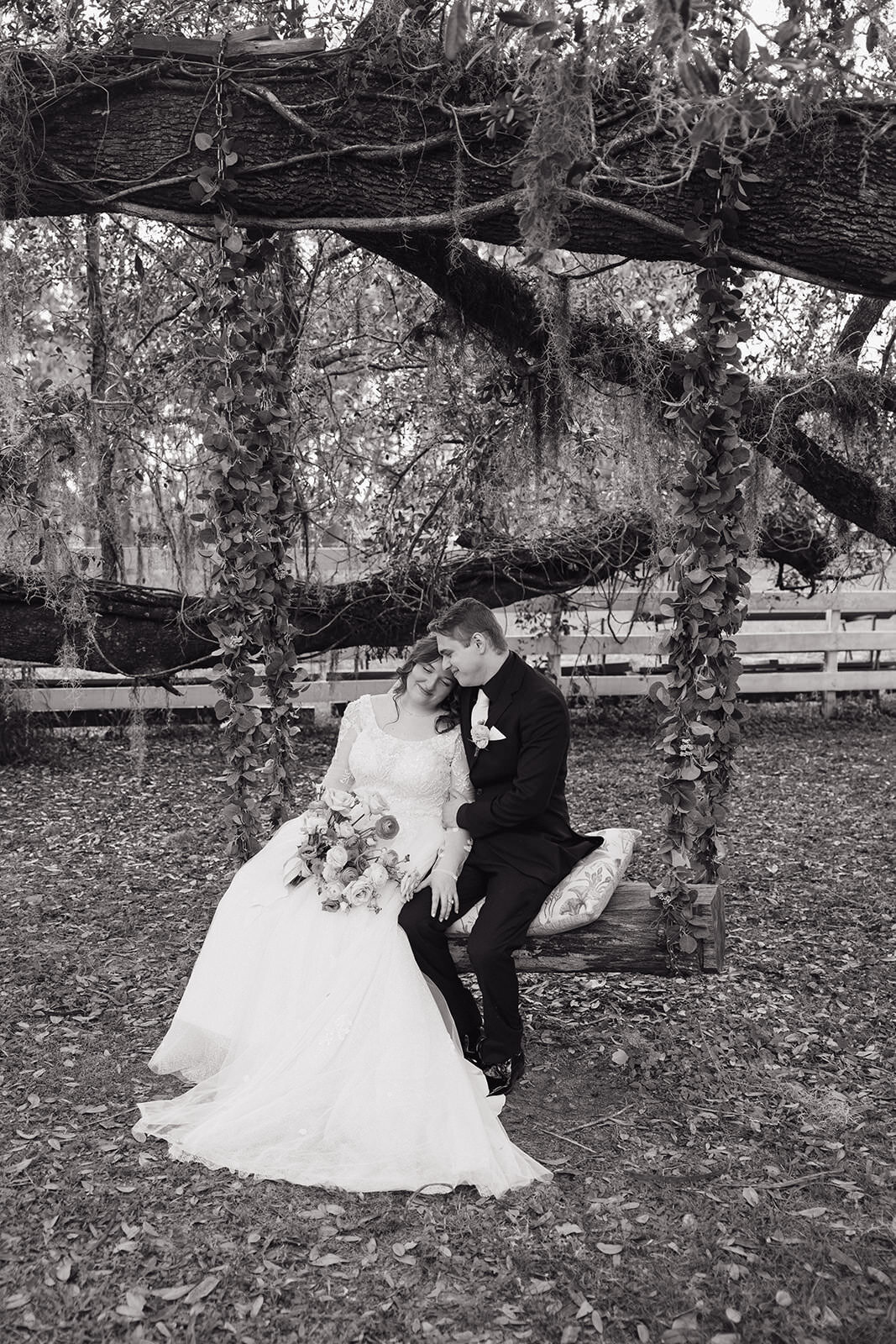 Black and white portrait of bride and groom walking the grounds at Uliana Estate in Lakeland FL.