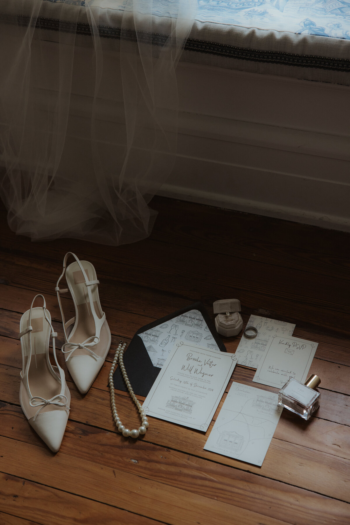 flatlay details of invitations, shoes and rings