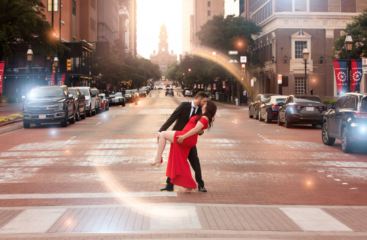 couple-dipping-in-crosswalk-in-downtown-fort-worth-wife-in-red-dress
