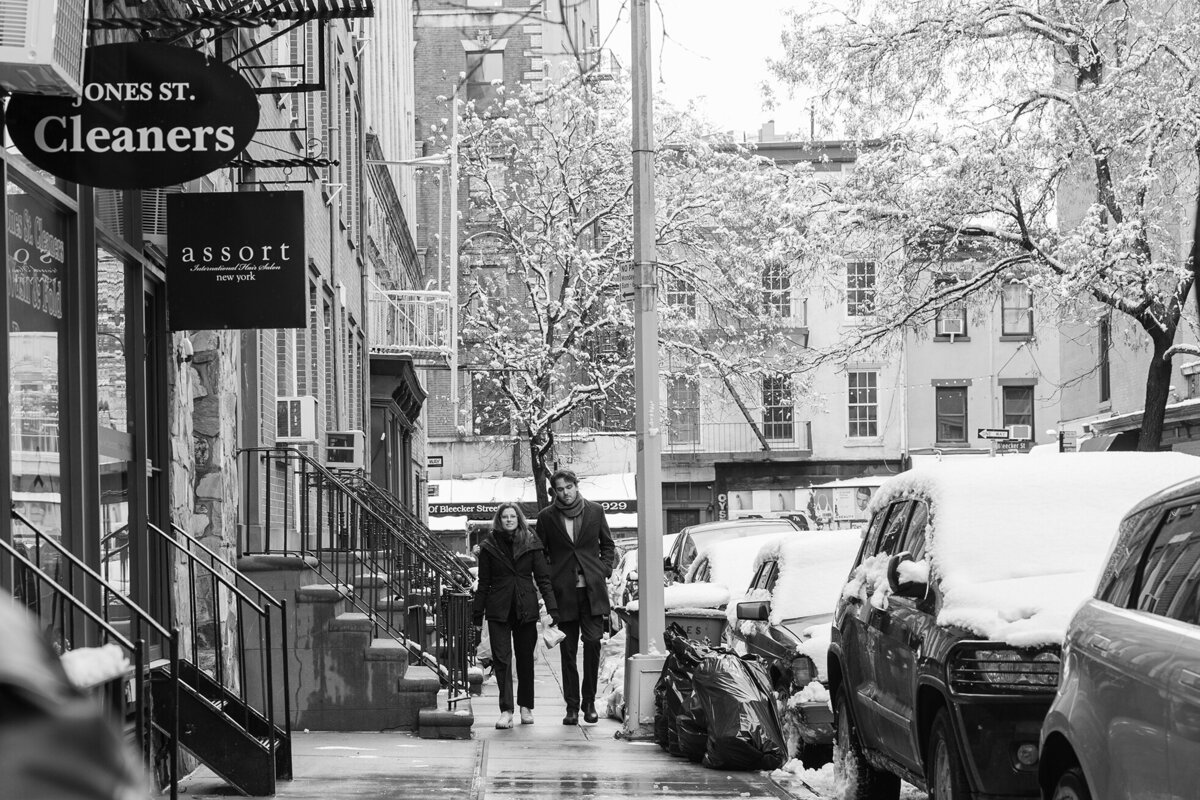 Young couple walkg to their SOHO home during the winter morning.