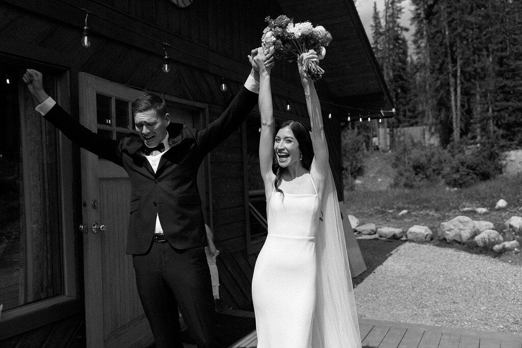 Bride and groom celebrating at wedding ceremony by Court Amber Photography, joyful and adventurous wedding photographer in Calgary, Alberta. Featured on the Bronte Bride Vendor Guide.