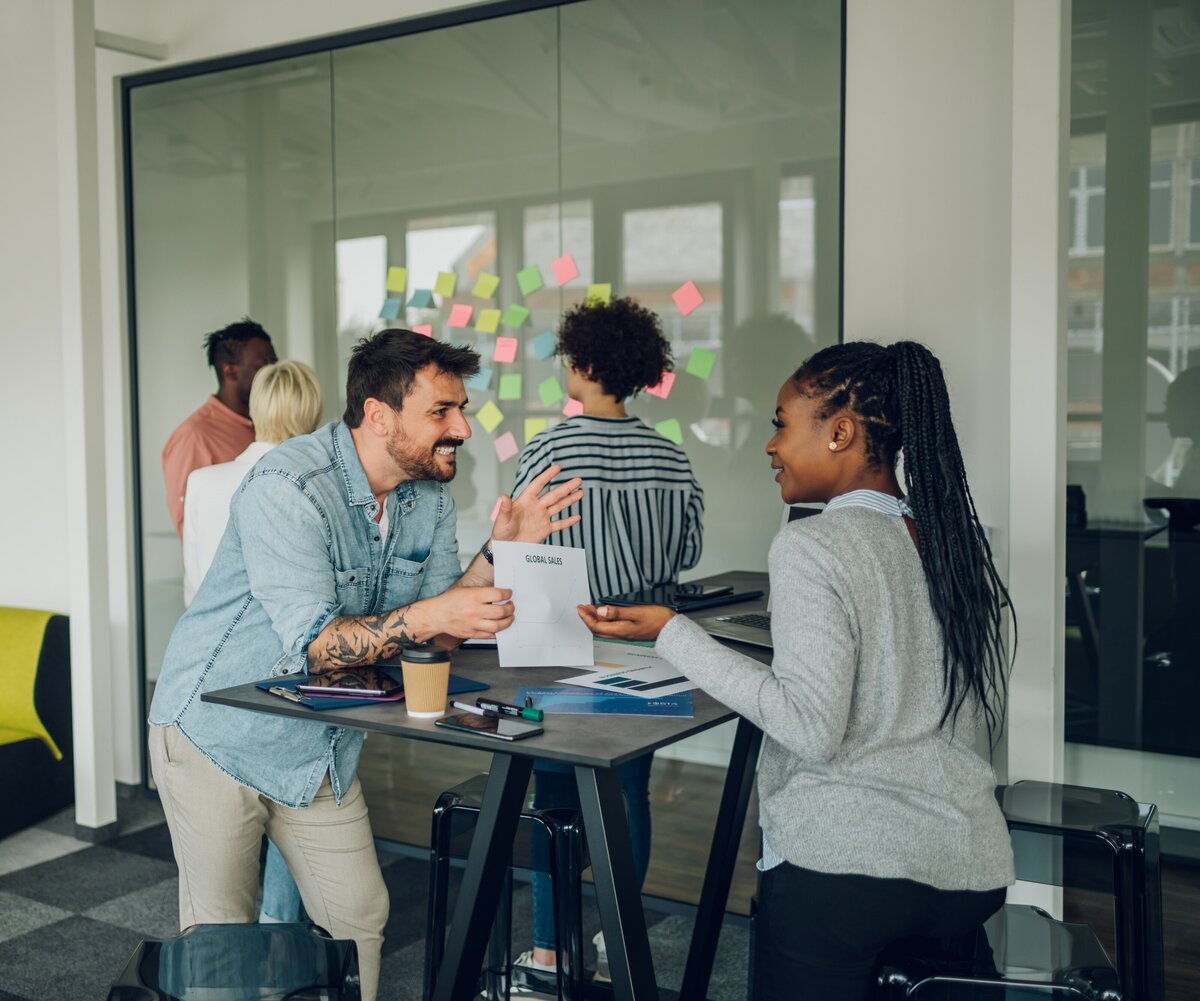 two-multiracial-colleagues-having-a-meeting-in-the-2025-04-01-13-22-55-utc