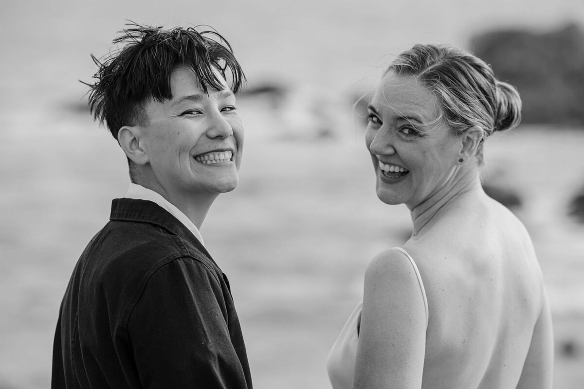 two brides during their elopement wedding smiling at the camera
