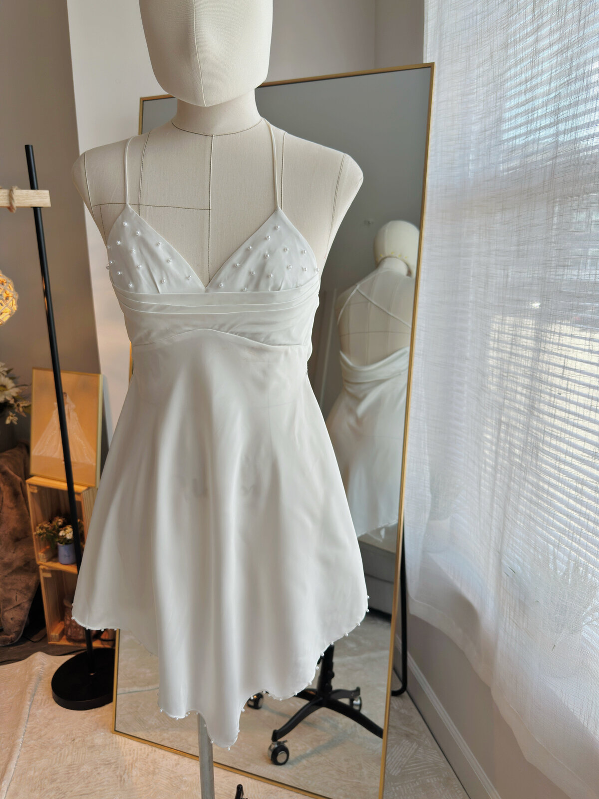 Modern minimalist bridal slip dress with subtle beaded details
