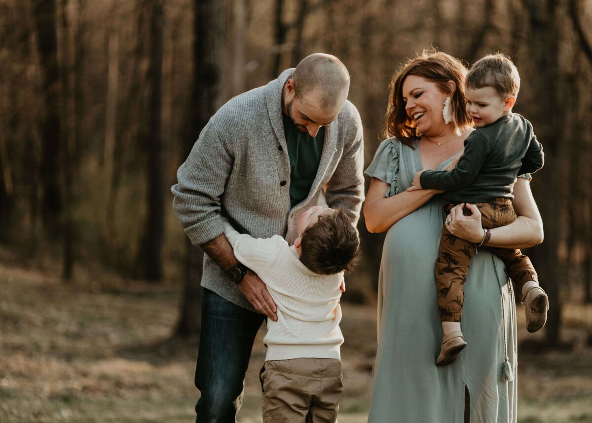 A maternity session in the woods with a pregnant woman and her two sons captured by a Pittsburgh maternity photographer.