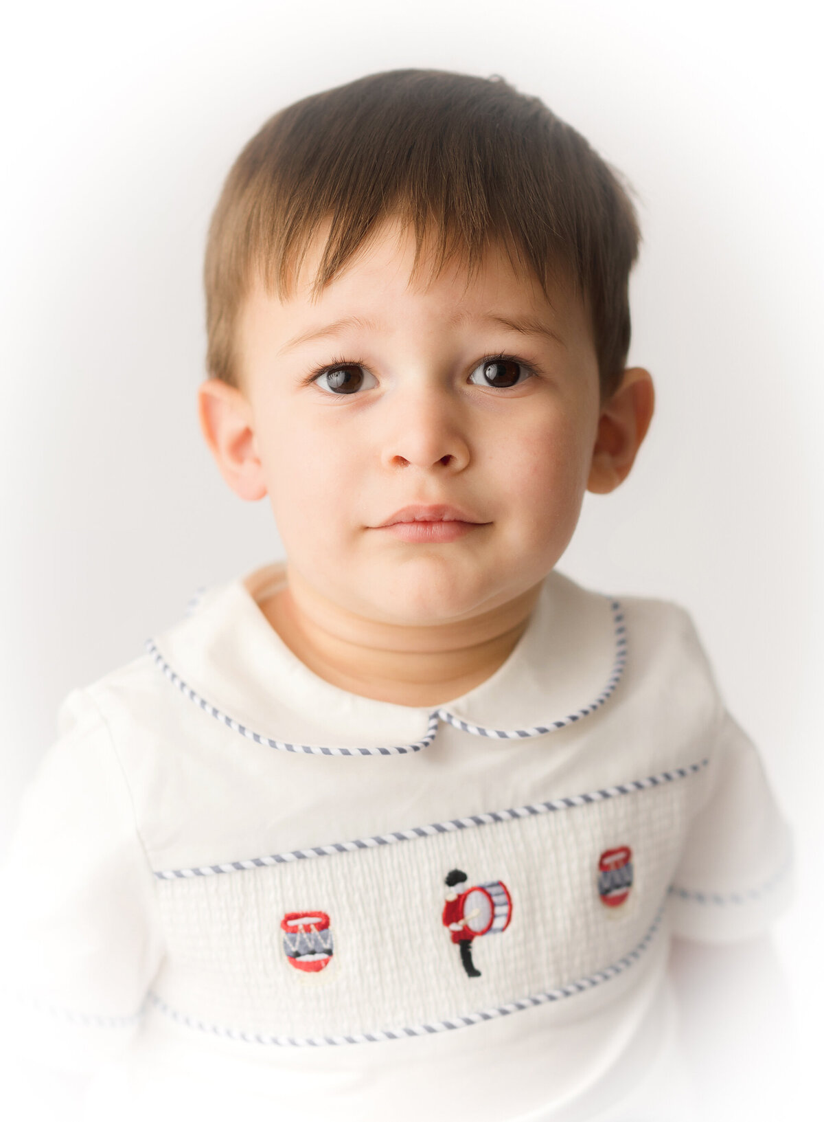 Little boy peers into the camera during Heirloom Portrait Photoshoot in Charleston, South Carolina.