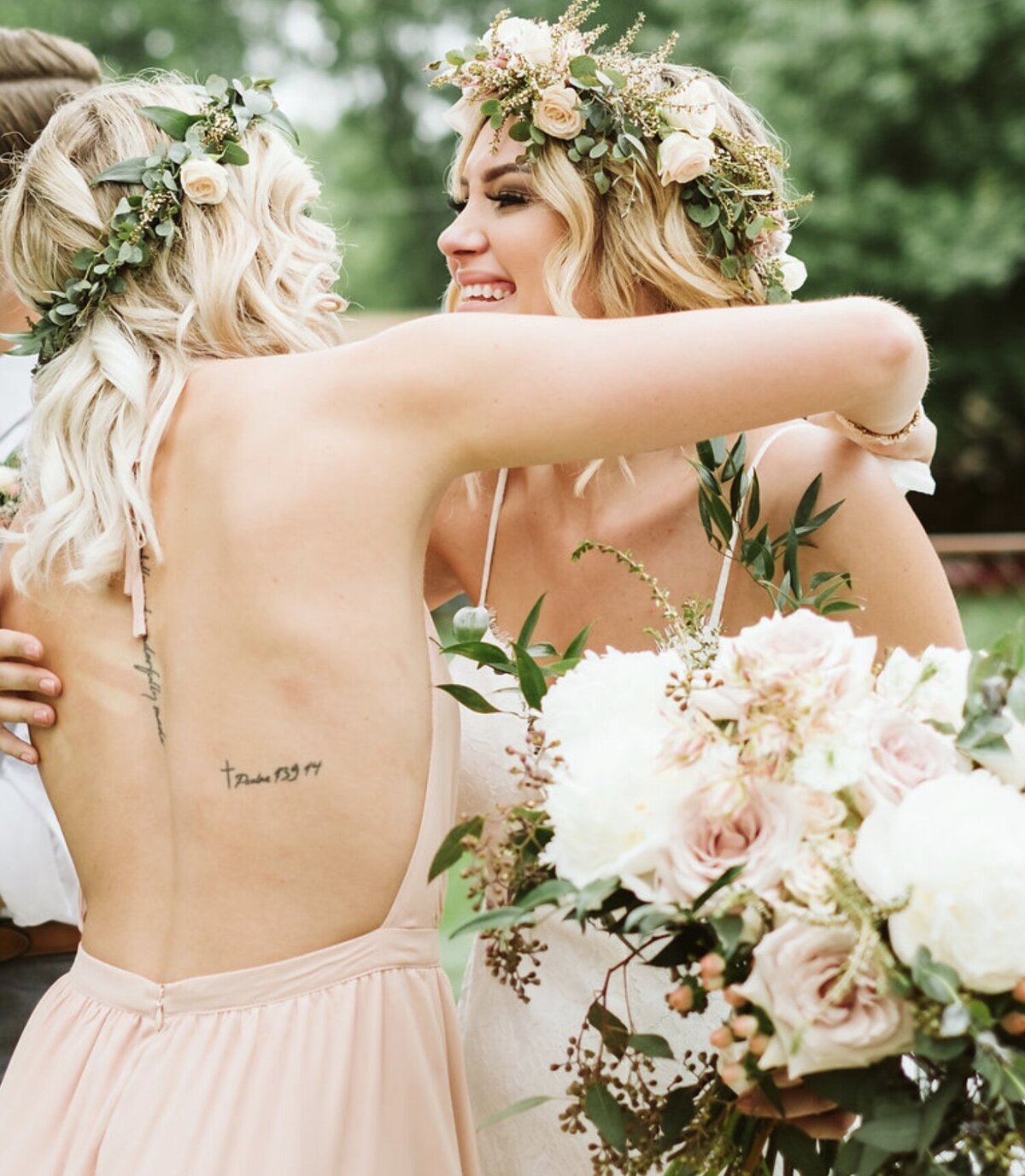 Bride and bridesmaid hugging