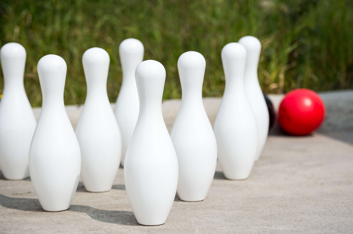 Ottawa event photography showing the setup of a bowling activity with white bowling pins and red ball as part of a corporate children's event.  Captured by JEMMAN Photography COMMERCIAL