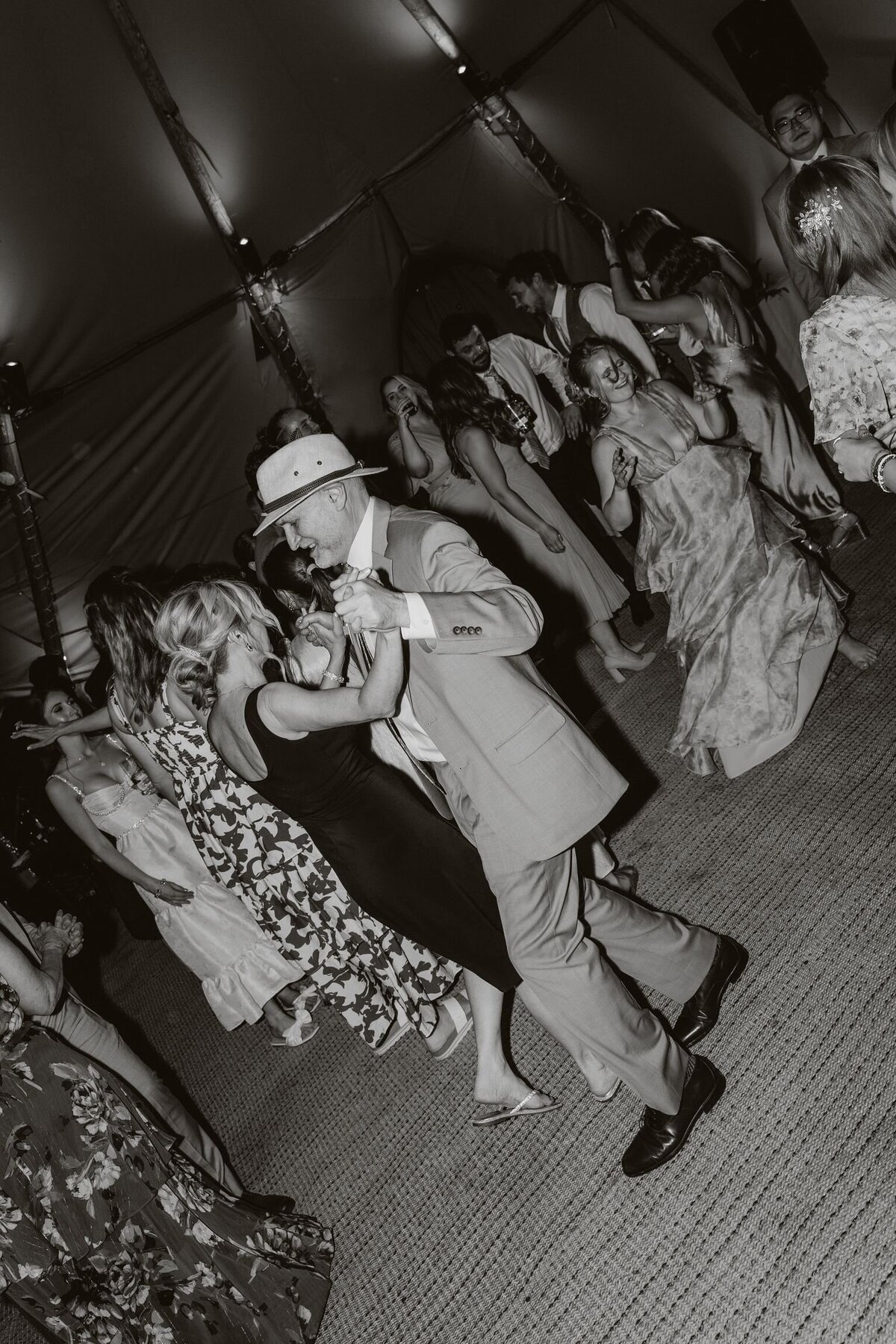 Mum and dad dancing on the dancefloor at their daughters wedding in Tenby