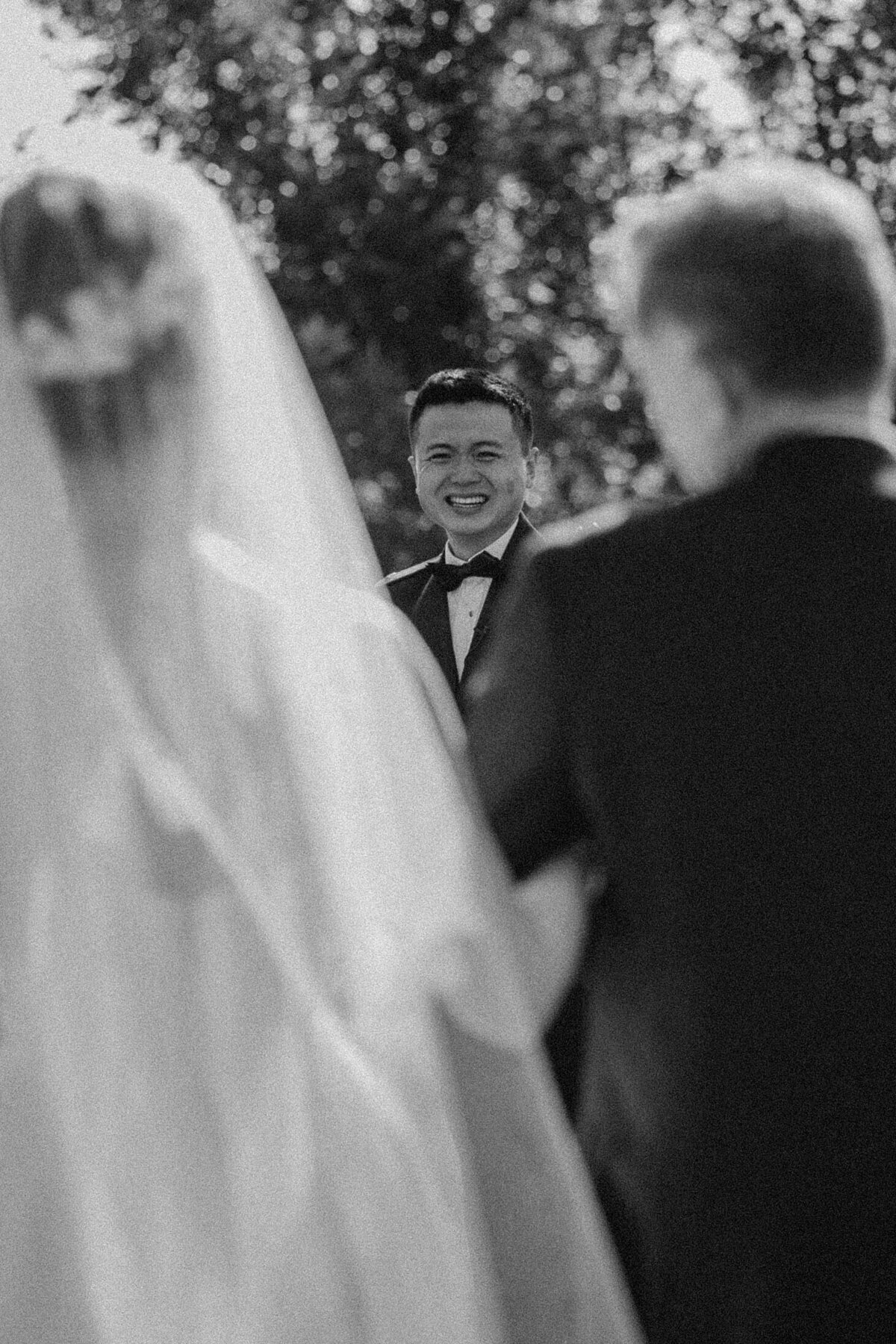 groom watching bride come down aisle