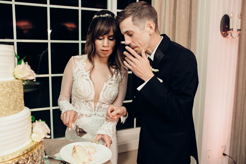 Wedding Photograph Of Bride And Groom placing The Slice Of Cake In Their Plate Los Angeles