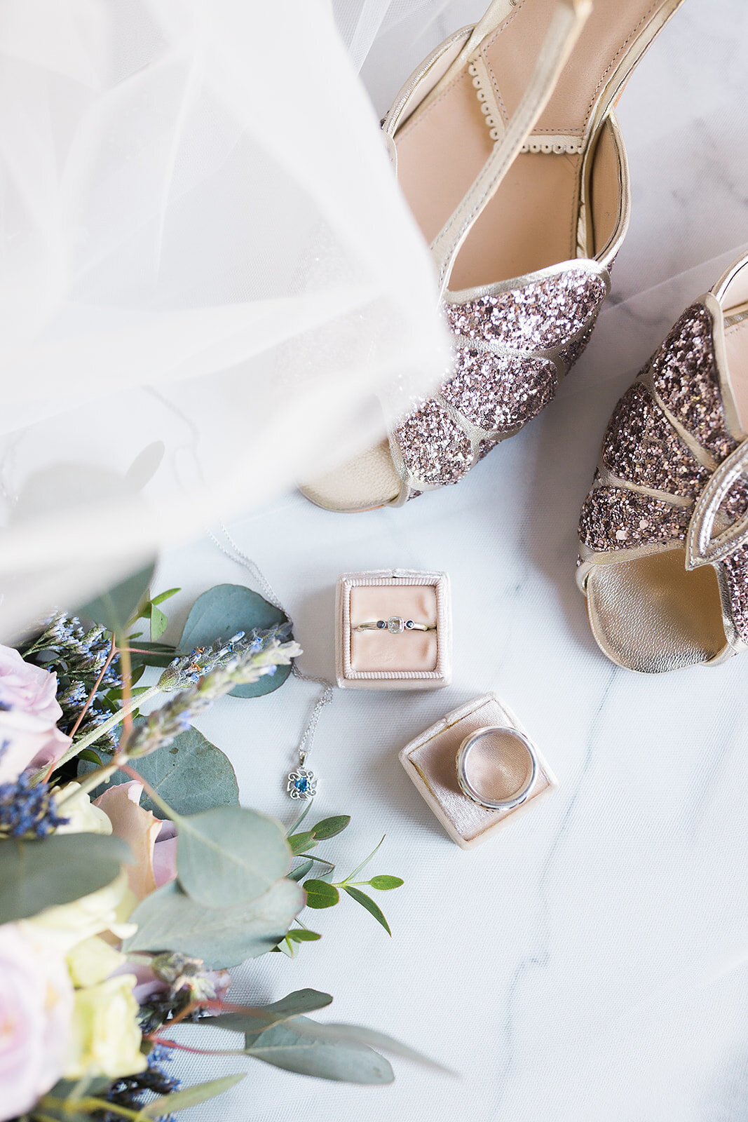 Flat lay of rings in a pink box and sparkly pink shoes