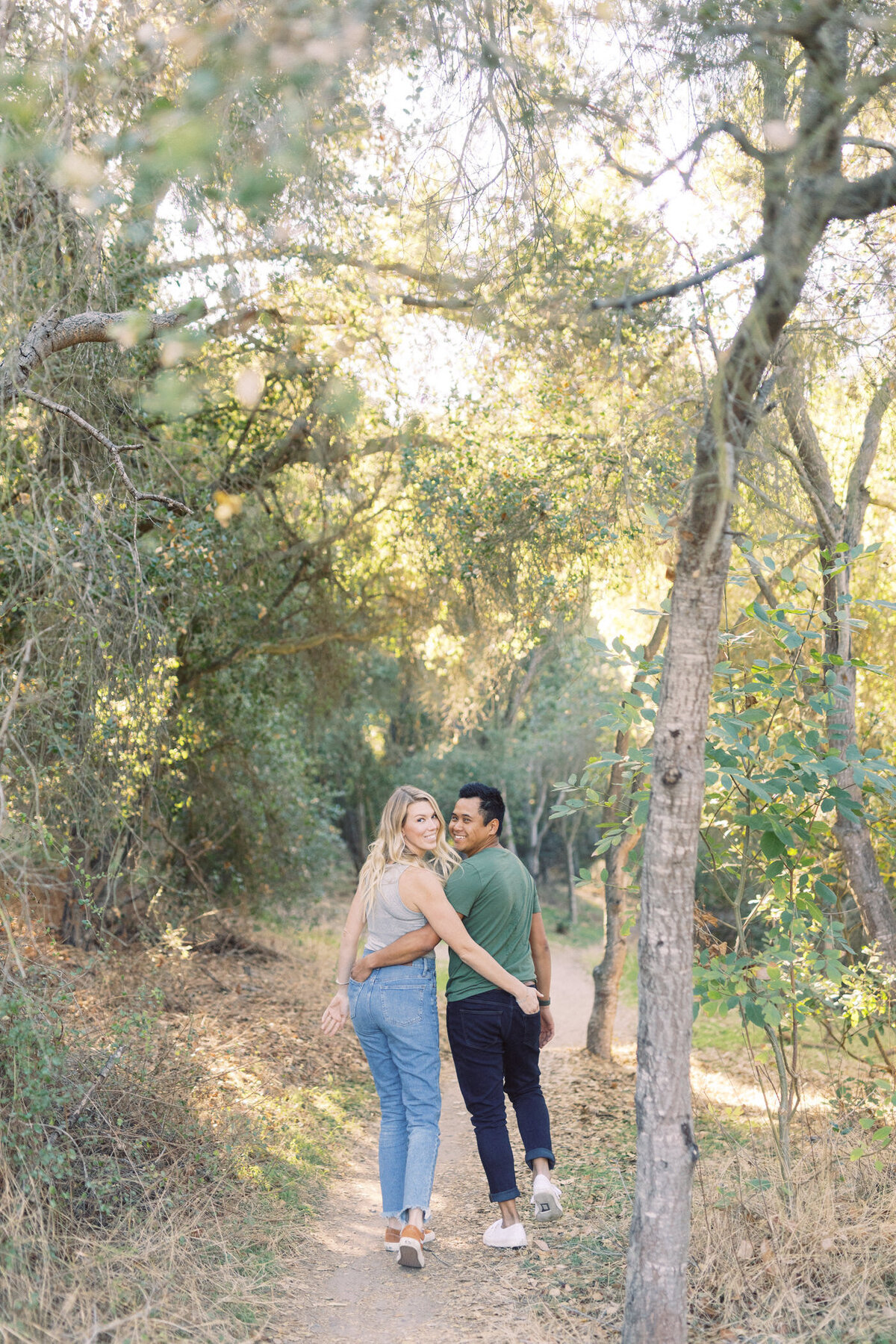 engagement session couple looking back and walking away