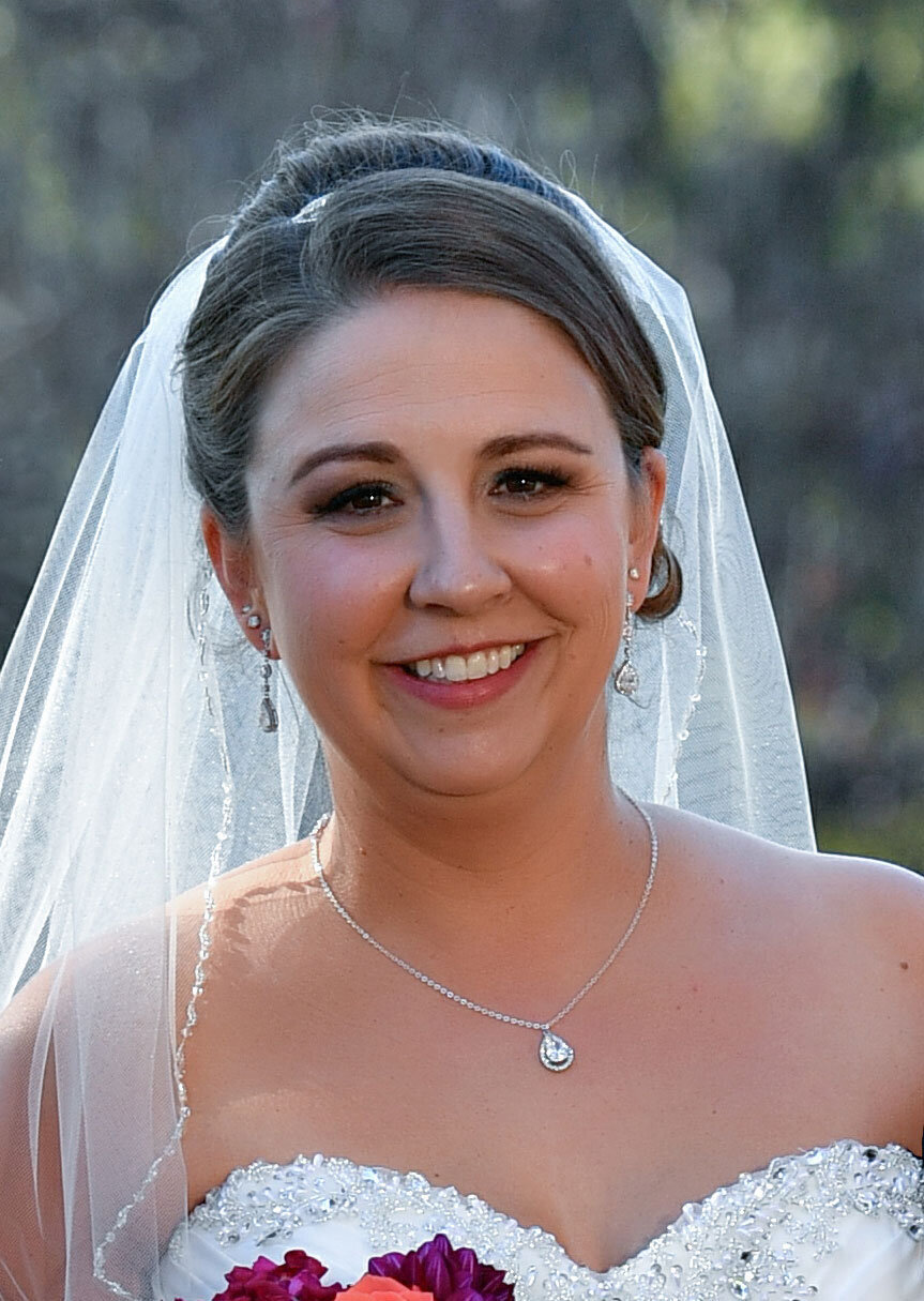 Brunette bride with classic bridal makeup with purple eye makeup lots of lashes