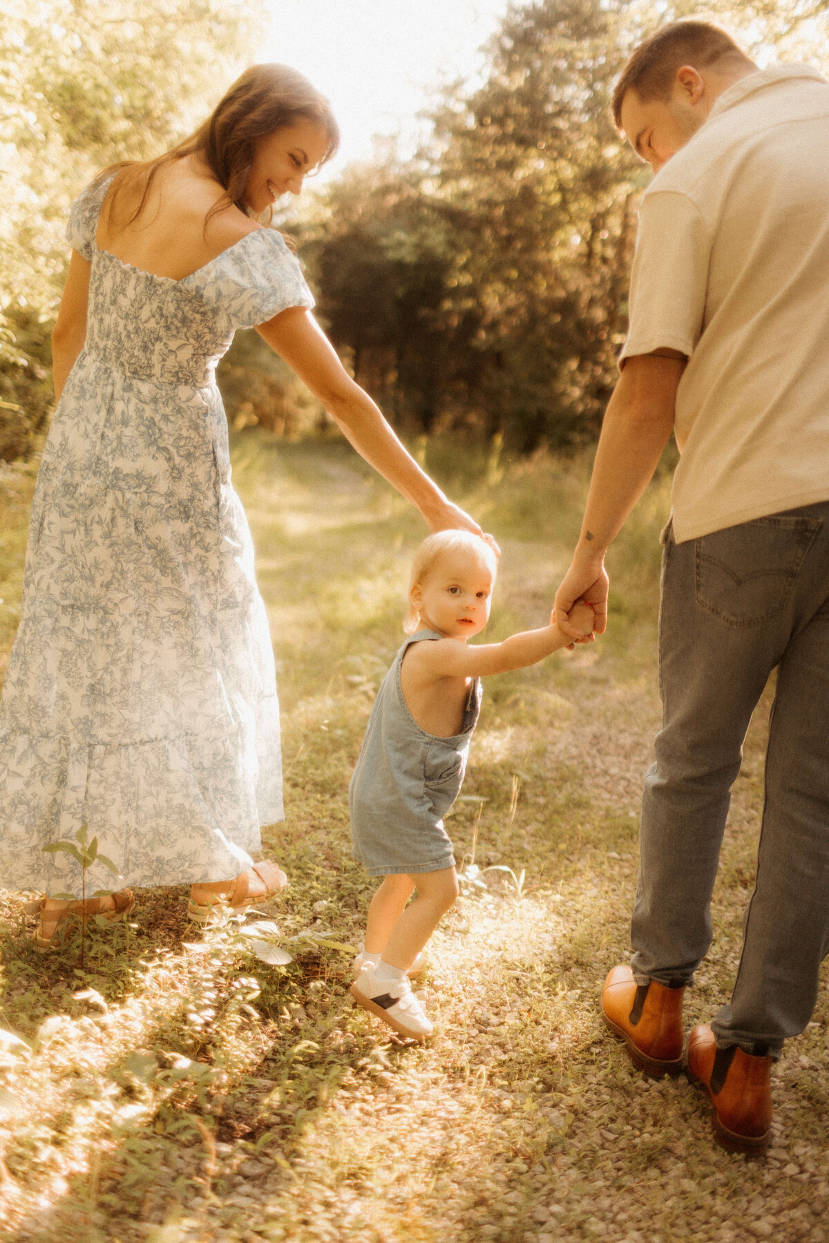 Parents lifting toddler into the air during Nashville TN park family photography