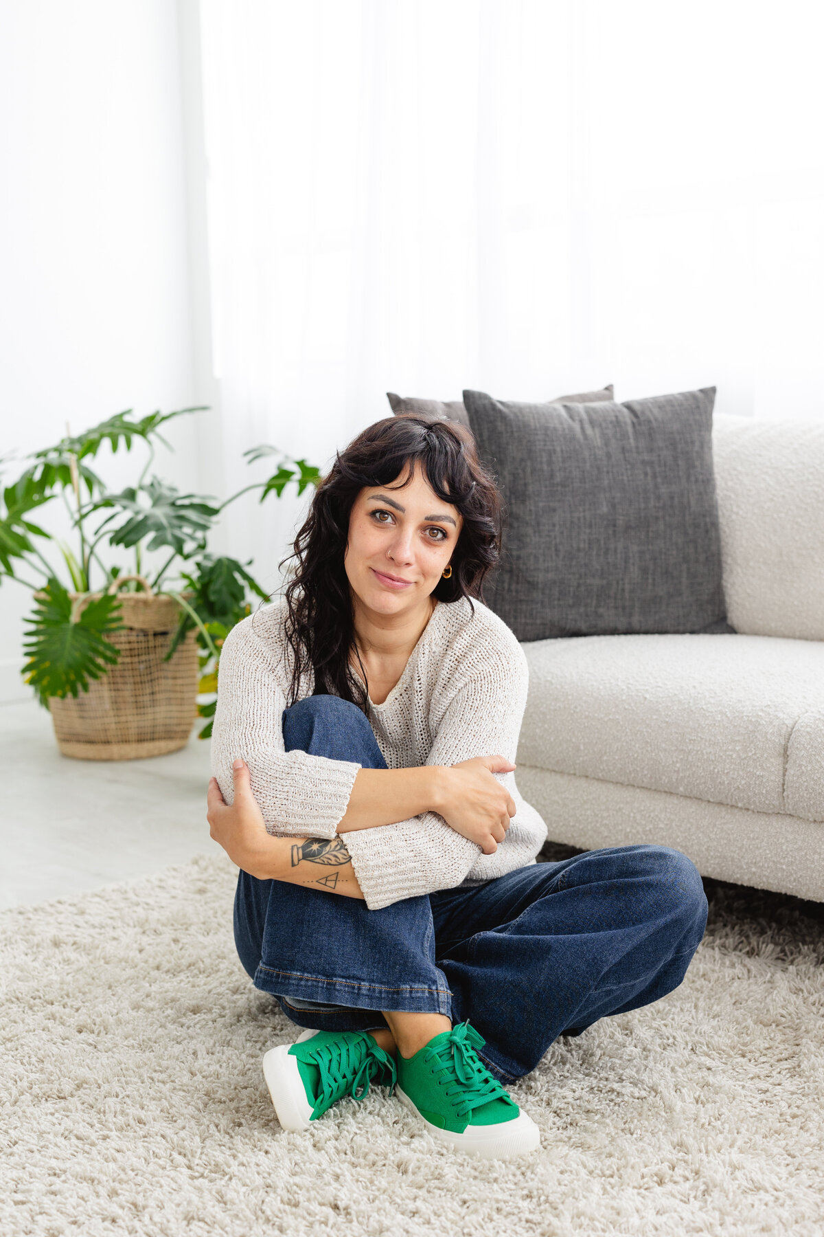 Jess in casual wear posing for a branding photography session on the floor at the photography studio.