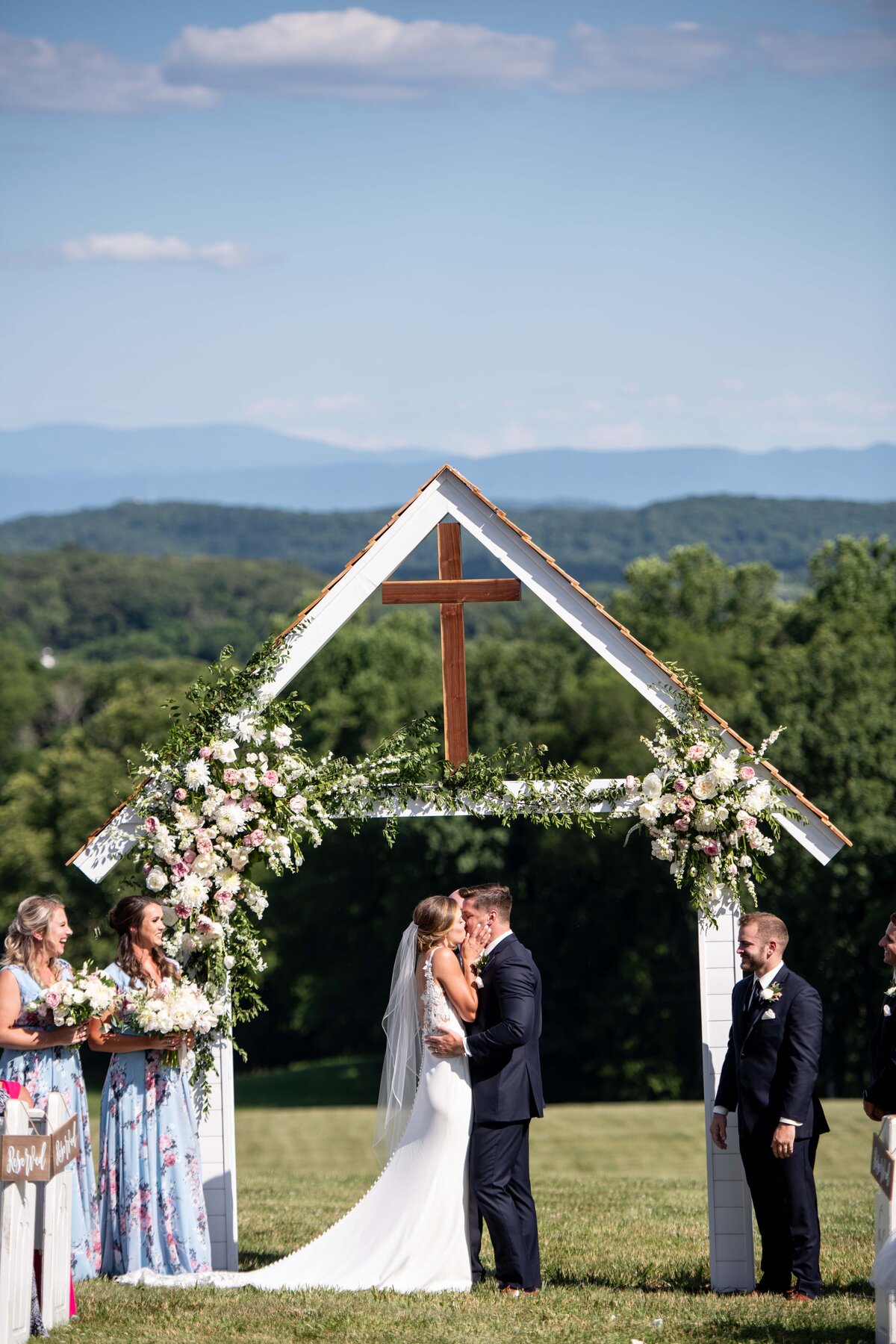 first kiss at wedding with mountains in the background