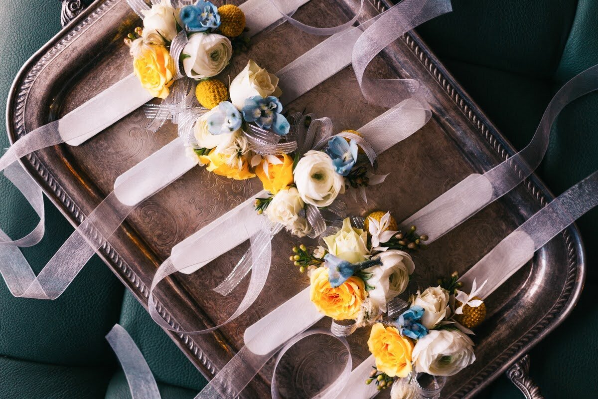 Wedding floral corsages on a tray.