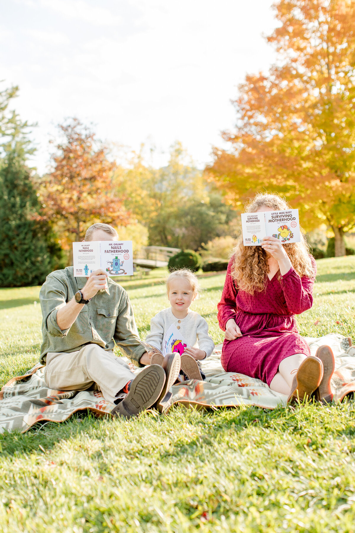 Family session photo in Banner Elk, NC of a mom and dad being silly with their son during a fall family photo session.